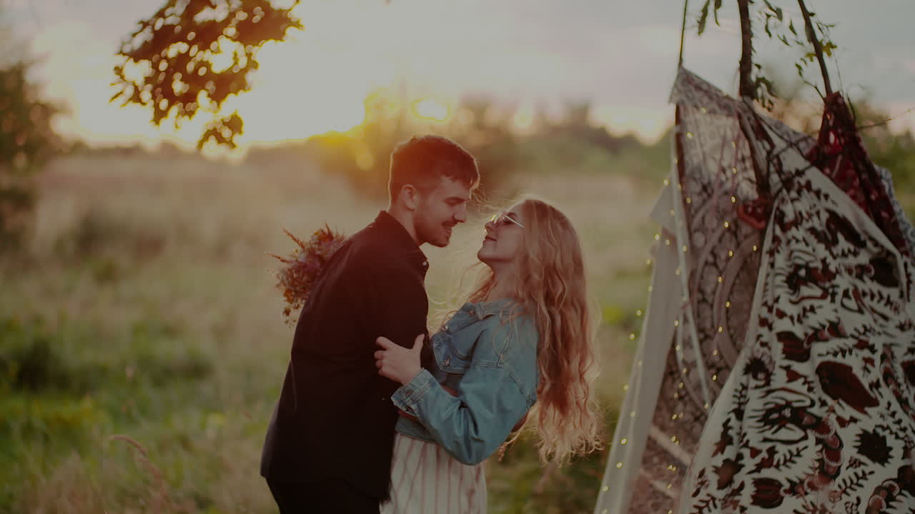 Young Attractive Couple Embracing And Smiling While On Camp