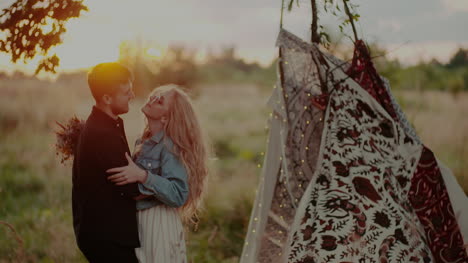 Young-Attractive-Couple-Embracing-And-Smiling-While-On-Camp