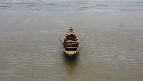 Abandoned-wooden-boat-on-empty-sand-beach-loneliness-concept,-drone-dolly-out