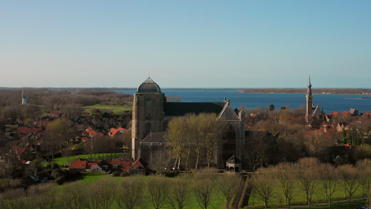 Aerial view of a church, cityscape, and lake
