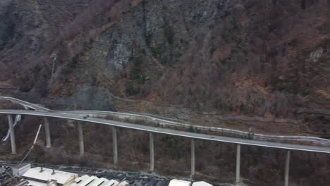 Egratz-Viaduct-Bridge---a-long,-curved-concrete-highway-bridge-in-the-French-Alps---aerial-panorama