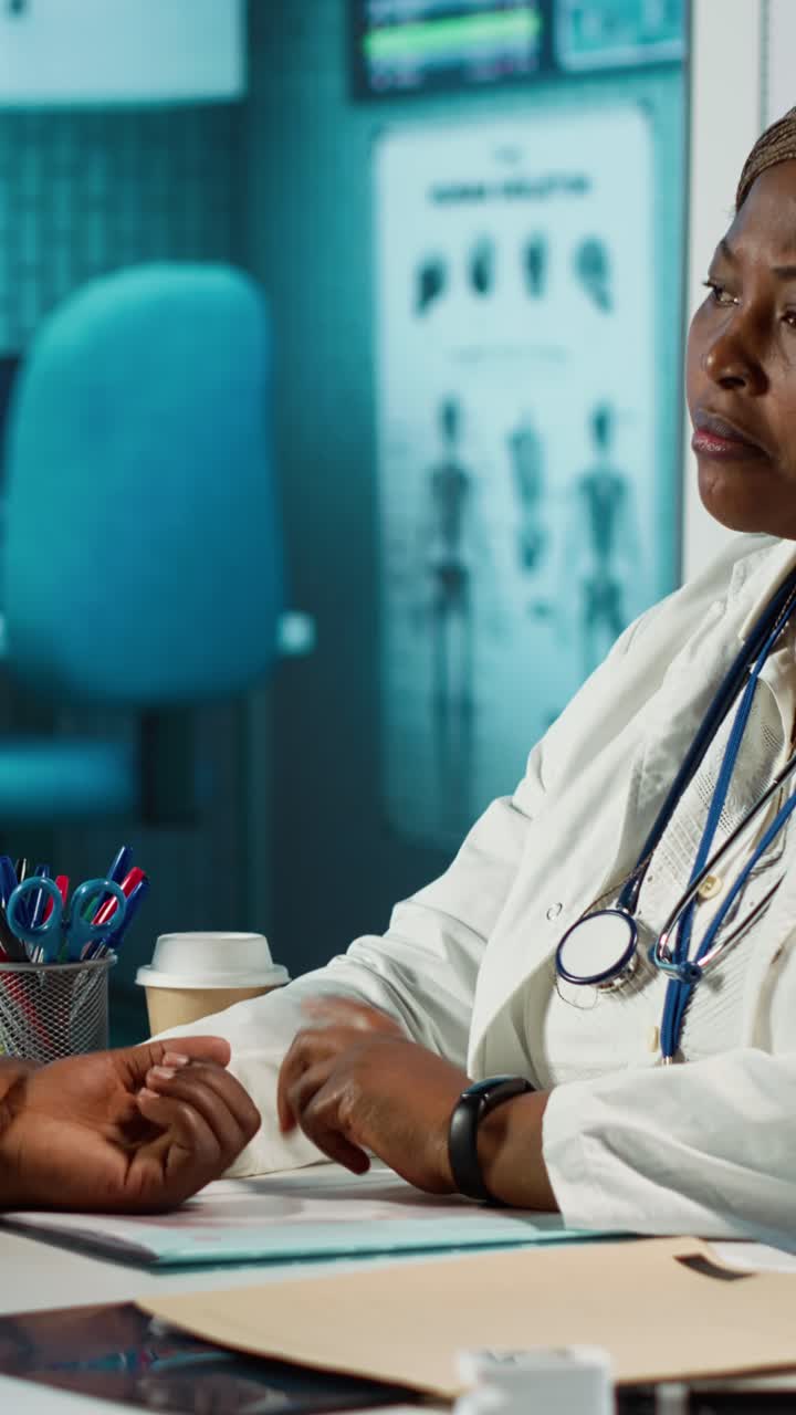 African American Doctor Checking Patient's Pulse in Clinic