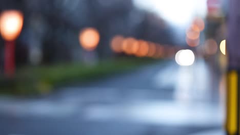 out-of-focus lights along a wet urban street