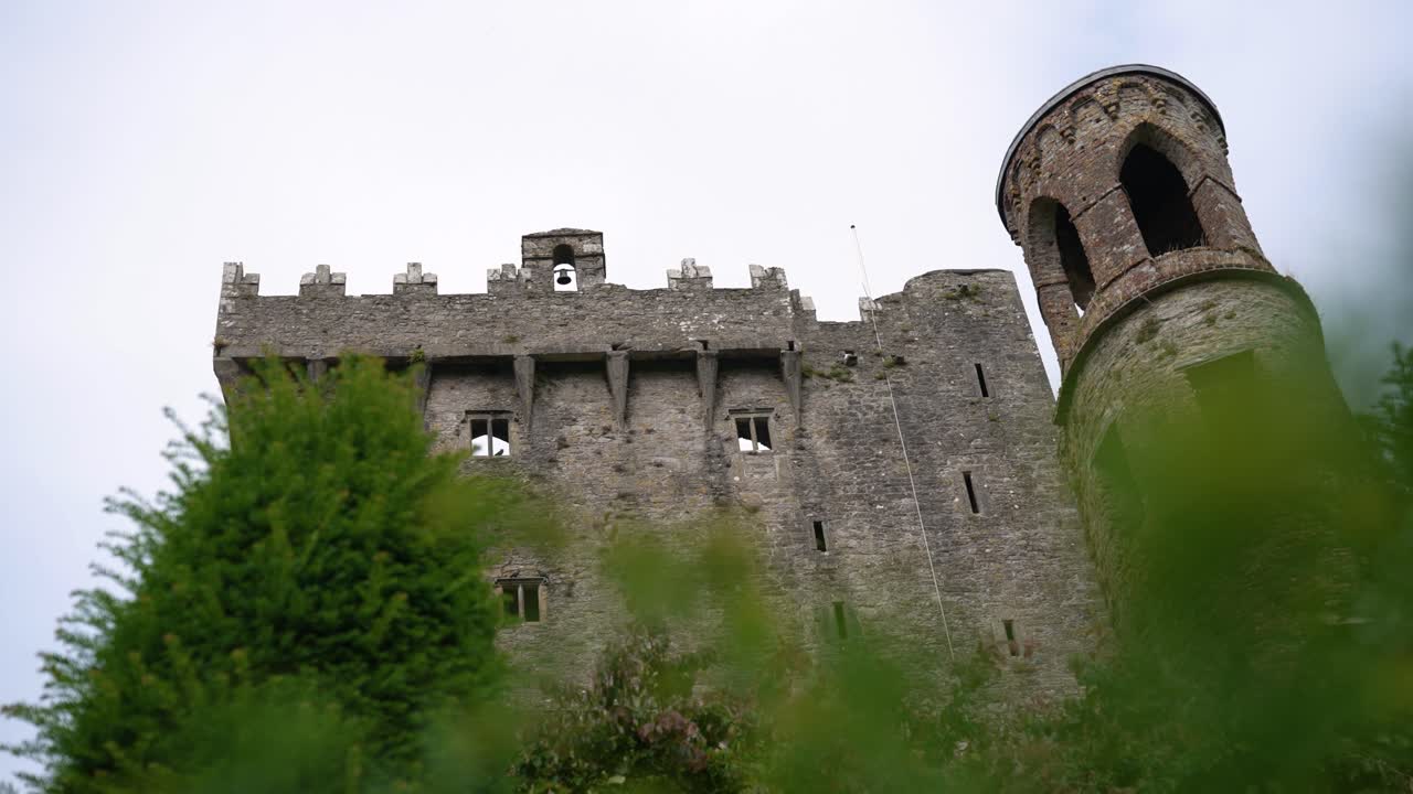 A low-angle panning shot of the iconic Blarney Castle in County Cork, Ireland, home of the legendary Blarney Stone. A perfect clip for any travel or history-themed project
