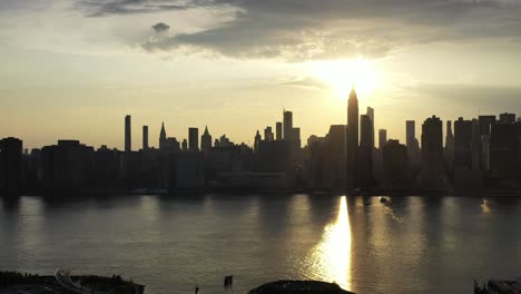 Ein-Langsamer,-Dramatischer-Schwenk-Nach-Rechts-Einer-Drohnenkamera,-Luftaufnahme-Der-Ostseite-Von-New-York-City,-Während-Eines-Goldenen-Sonnenuntergangs-Im-Sommer