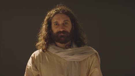 Portrait-Of-Man-With-Long-Hair-And-Beard-Representing-Figure-Of-Jesus-Christ-Extending-Hand-In-Friendship