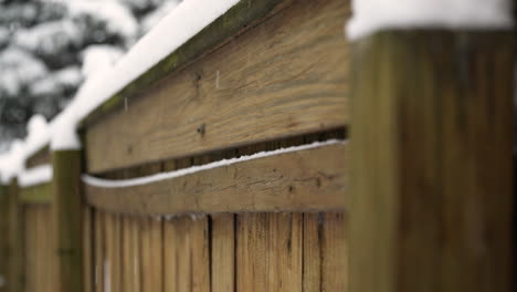 snow falling against fence in slow motion