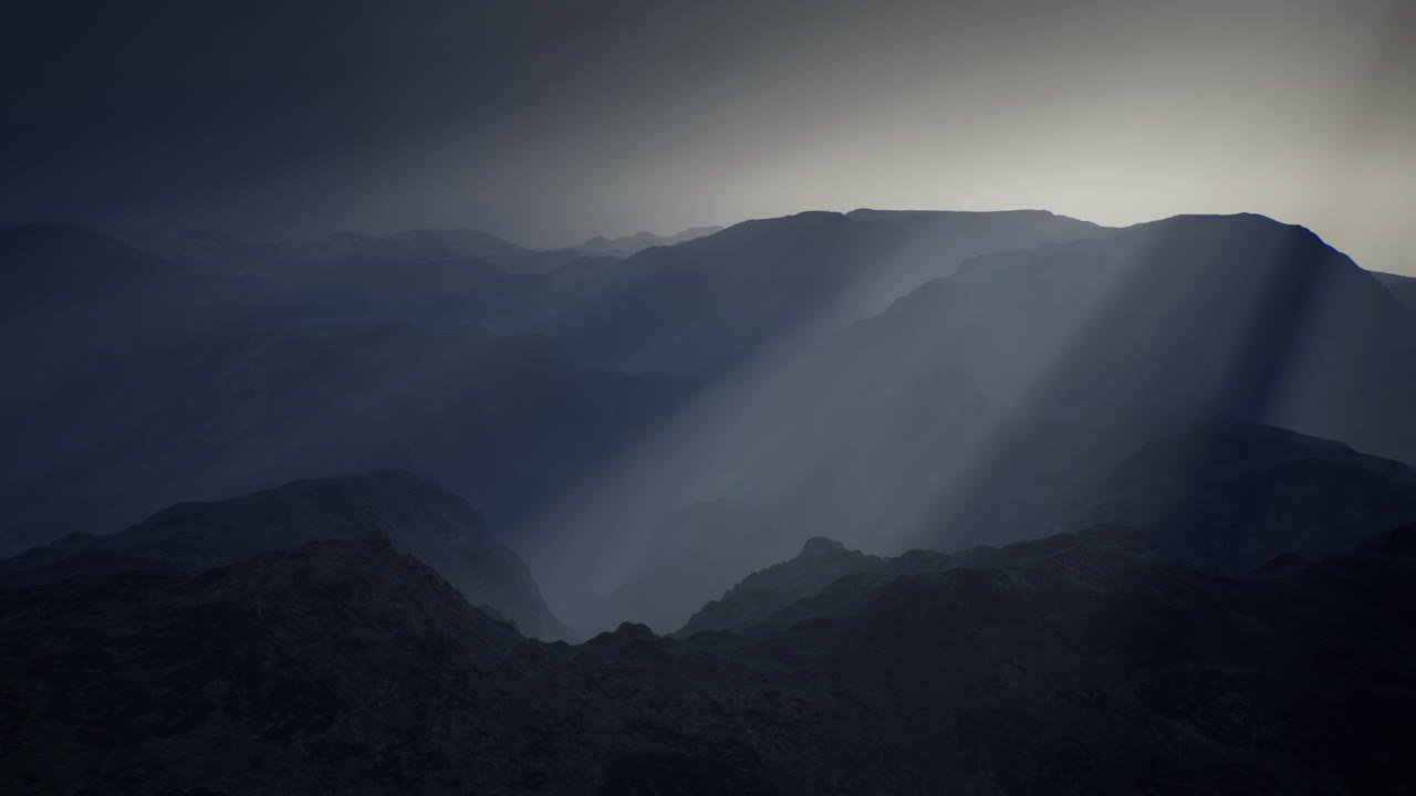 Mountains under dramatic cloud cover at dusk with striking sun rays