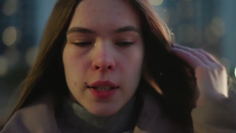 close-up front shot of a girl's face with a blurred background. the video highlights her facial features with sharp detail against a soft-focus backdrop, capturing a natural, intimate atmosphere