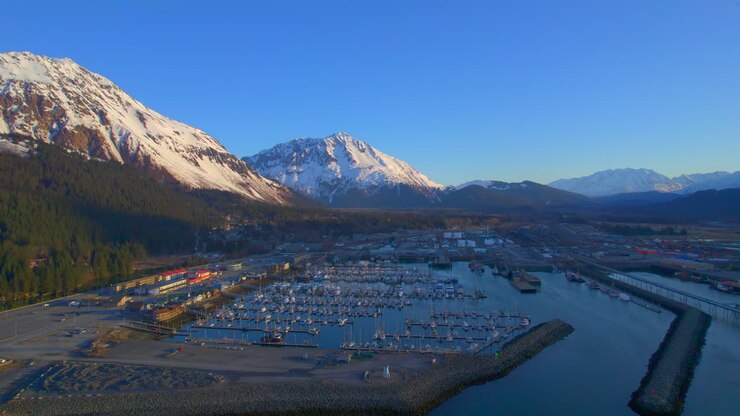 Sunrise flyover of Seward Boat Harbor and mountains inn Seward Alaska