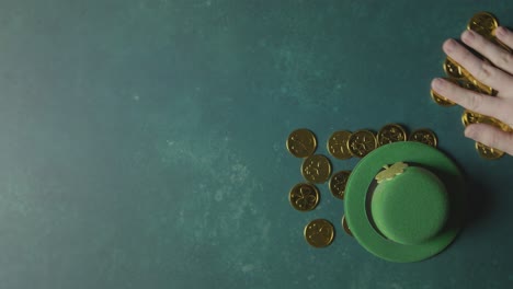 Overhead-Studio-Shot-Of-Green-Leprechaun-Top-Hat-And-Piles-Of-Gold-Coins-To-Celebrate-St-Patricks-Day-2