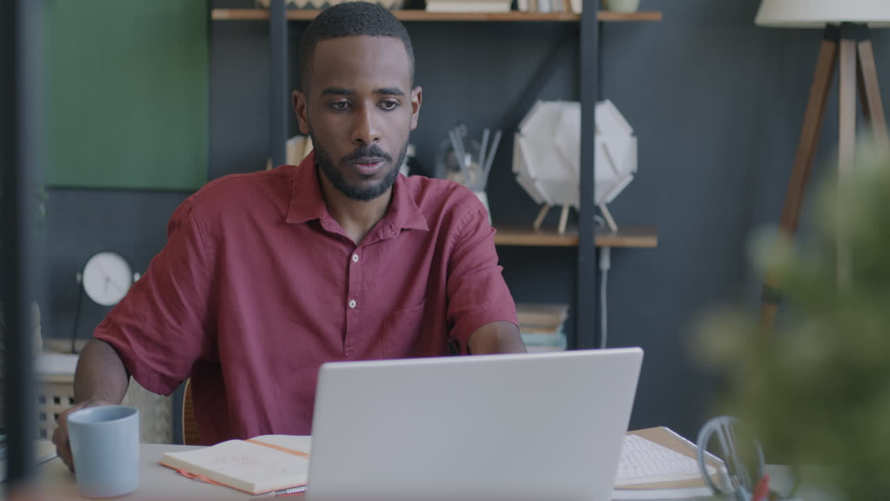 Man Working on Laptop in Home Office