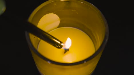 high angle of a candle being lit in slow motion