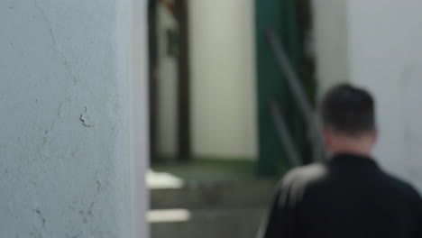 man walking down stairs in a building