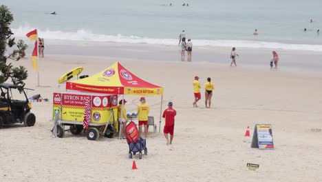 lifeguards and beachgoers near a vibrant station