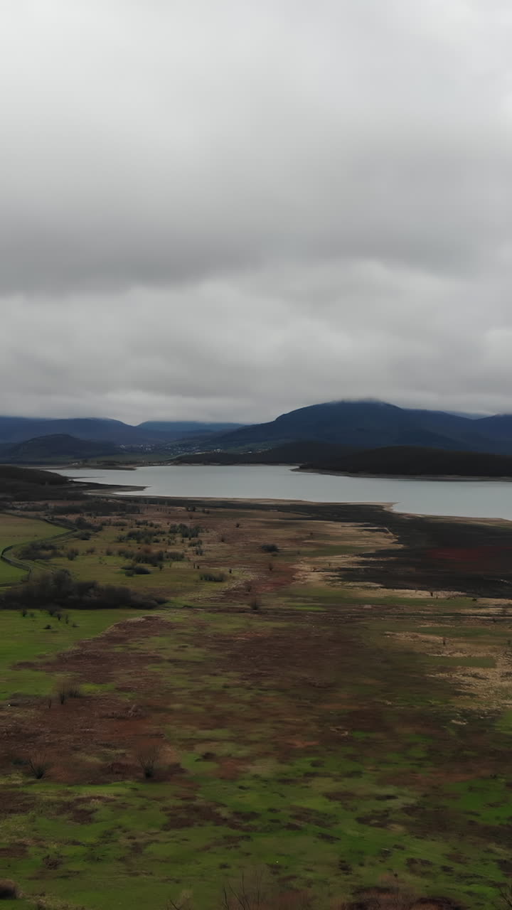 Cloudy Landscape with Lake and Mountains
