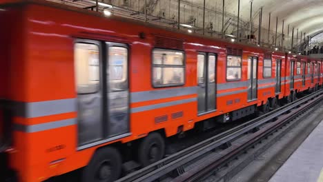 mexico city subway train pulling away from the station