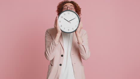 Happy-smiling-stylish-man-holding-office-clock-hiding-behind-checking-time-on-watch-obscuring-face