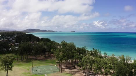 drone shot over the waimānalo beach park's basketball court in hawaii