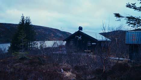 wooden cabin by the lake in åfjord, norway - wide shot