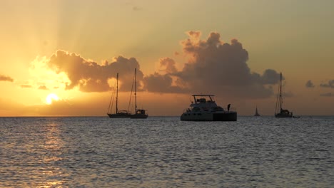 Catamaran-anchoring-on-a-beautiful-golden-evening,-in-Slow-Motion