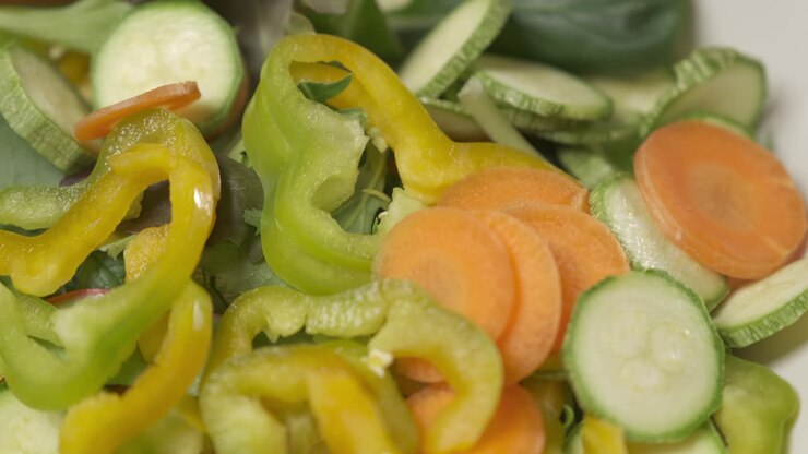 Mixed vegetables food, healthy vegetarian vegan meal, Mediterranean diet mix, raw sliced carrot zucchini pepper salad