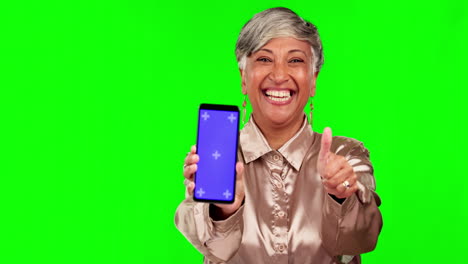 Thumbs-up,-phone-and-woman-in-a-studio-with-green