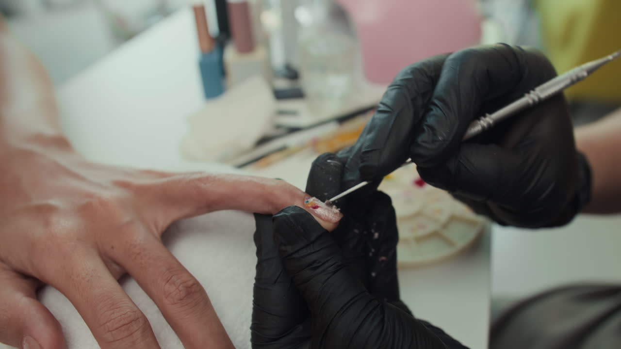 Gloved Hands of Manicurist Removing Polish from Clients Nails