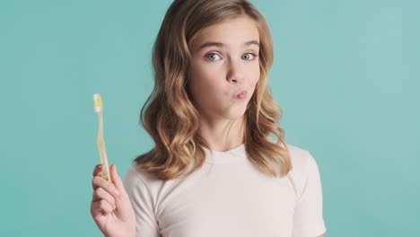 Teenage-Caucasian-girl-in-pijamas-holding-toothbrush.