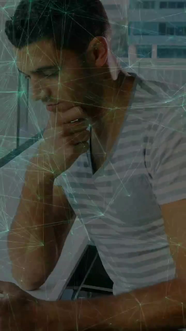 Vertical video: Man at window tapping phone, causing teal web overlay and checking data, smiling