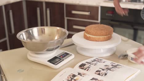 a girl puts a large silver bowl on the kitchen scale