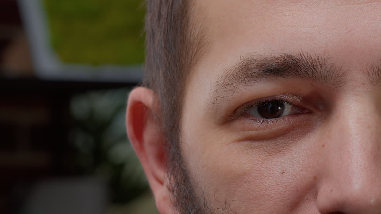 Macro shot portrait of male model showing one eye on camera