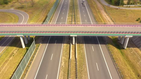 traffic of cars and trucks on the freeway in summer day - top view shot