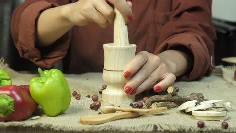 female hand pounding spices