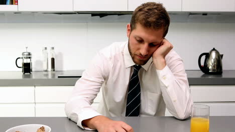 exhausted man having breakfast