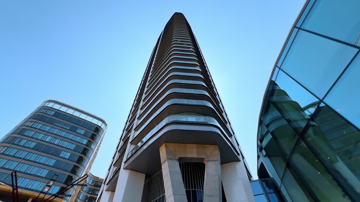 Modern design of the high-rise building in the scenery of the city. Low angle view at the tower in Bratislava, Slovakia
