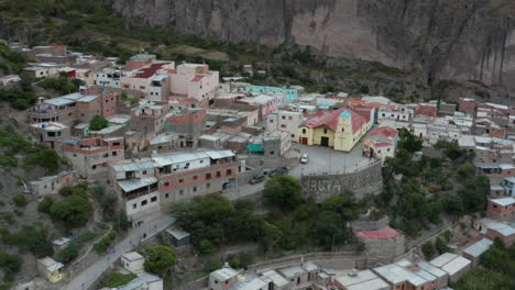 Aerial---small-town-of-Iruya,-Andes-mountains,-Argentina,-wide-lowering-shot