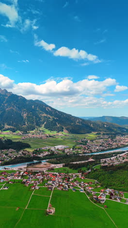 Iconic view of a little town scattered among the mountains. Amazing panorama of Reutte District, Tyrol, Austria. Aerial perspective. Vertical video.