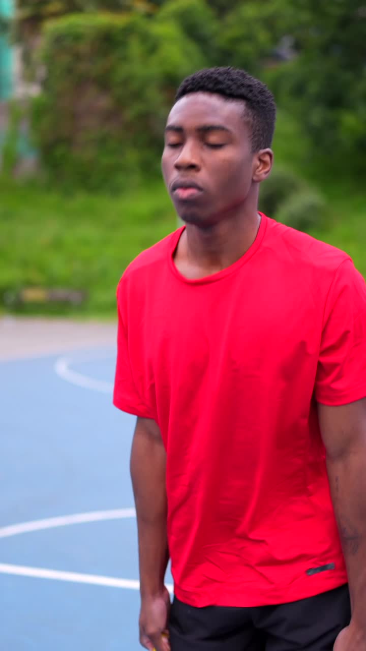 Man exercising with resistance band on basketball court