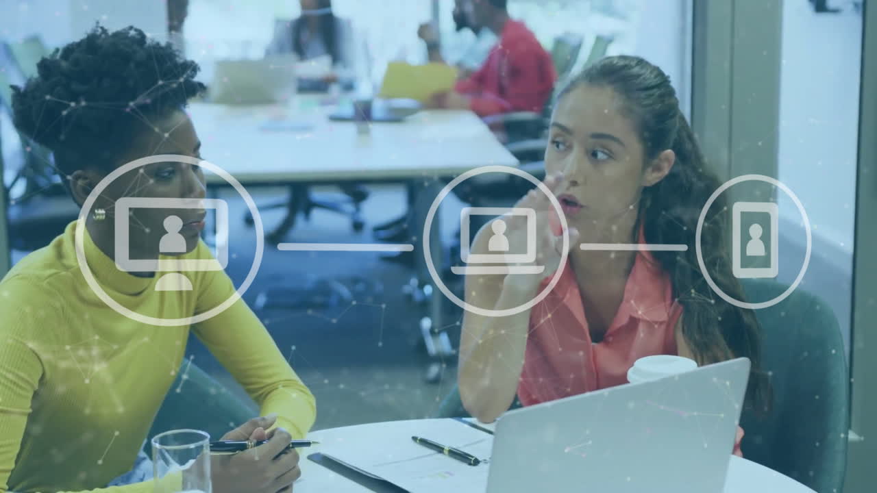 Animation of connected dots and flowchart over diverse female coworkers discussing reports on laptop