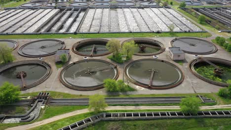 aerial shot of a wastewater treatment plant and distant skyline. big city waste processing concept