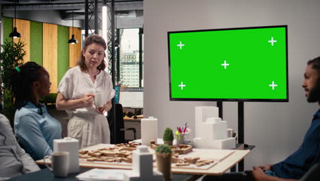 engineers real estate staff review blueprints with chroma key screen