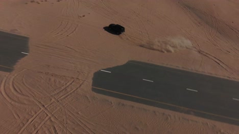 slow motion fpv drone clip of off road car in the desert