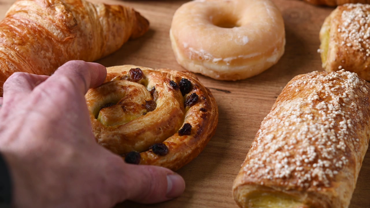 Hand picking a cinnamon roll