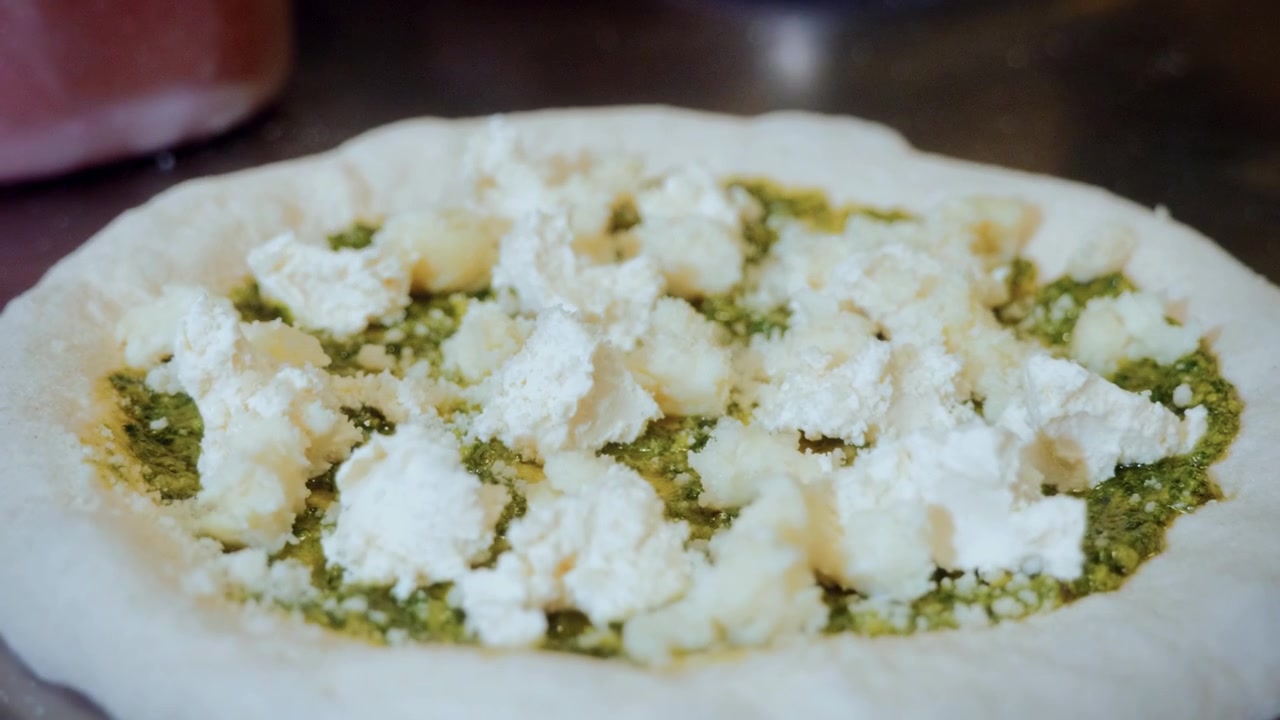 Autentico processo di preparazione della pizza in una pizzeria tradizionale italiana, con la pizza pronta per essere cotta
