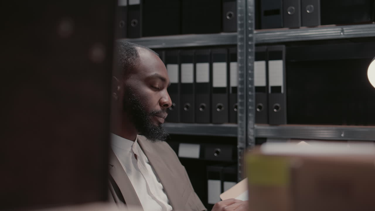 Man searching through files in a storage room