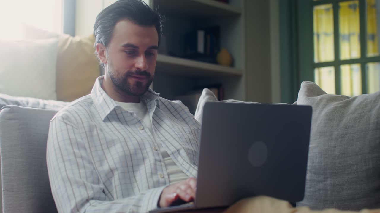 Man Working on Laptop at Home