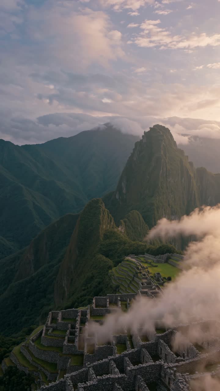 Aerial video captures Machu Picchu at sunrise, showcasing ancient ruins and misty mountains
