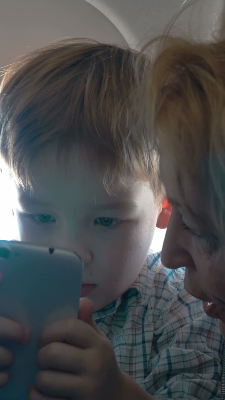 Child and Adult Using Phone