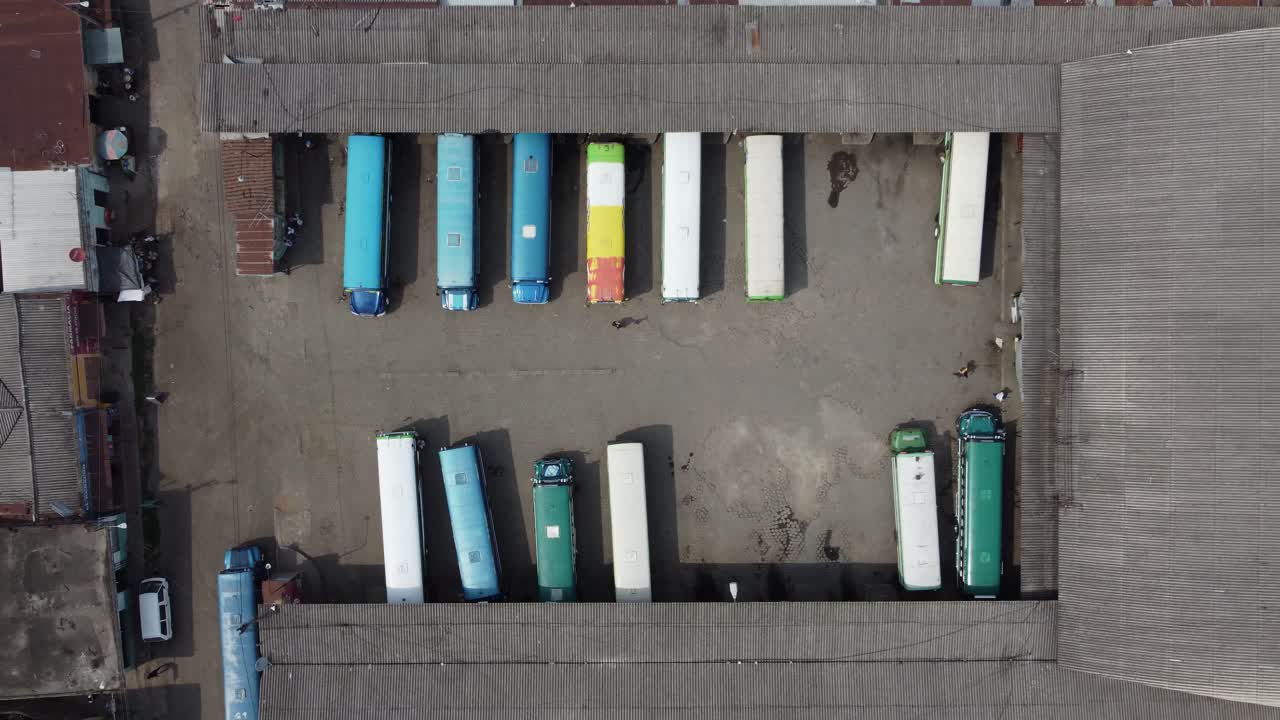 una antena recta hacia abajo se eleva sobre el depósito de autobuses de transporte local de el salvador